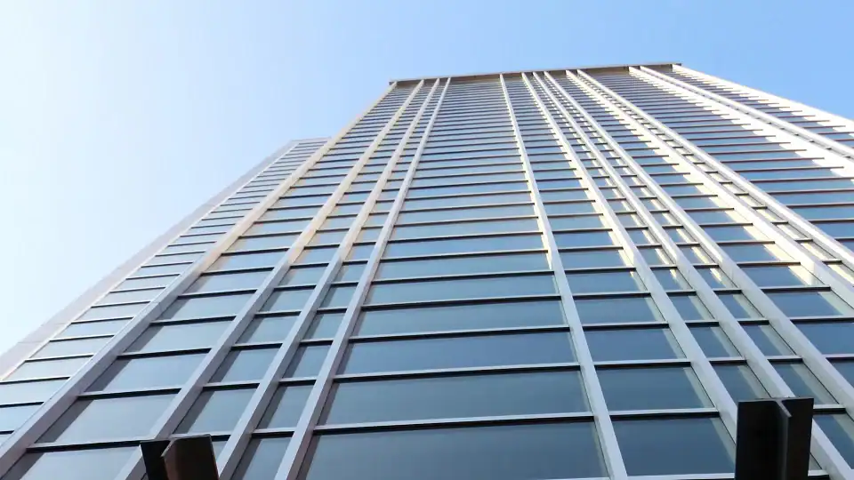 looking upward at glass skyscraper